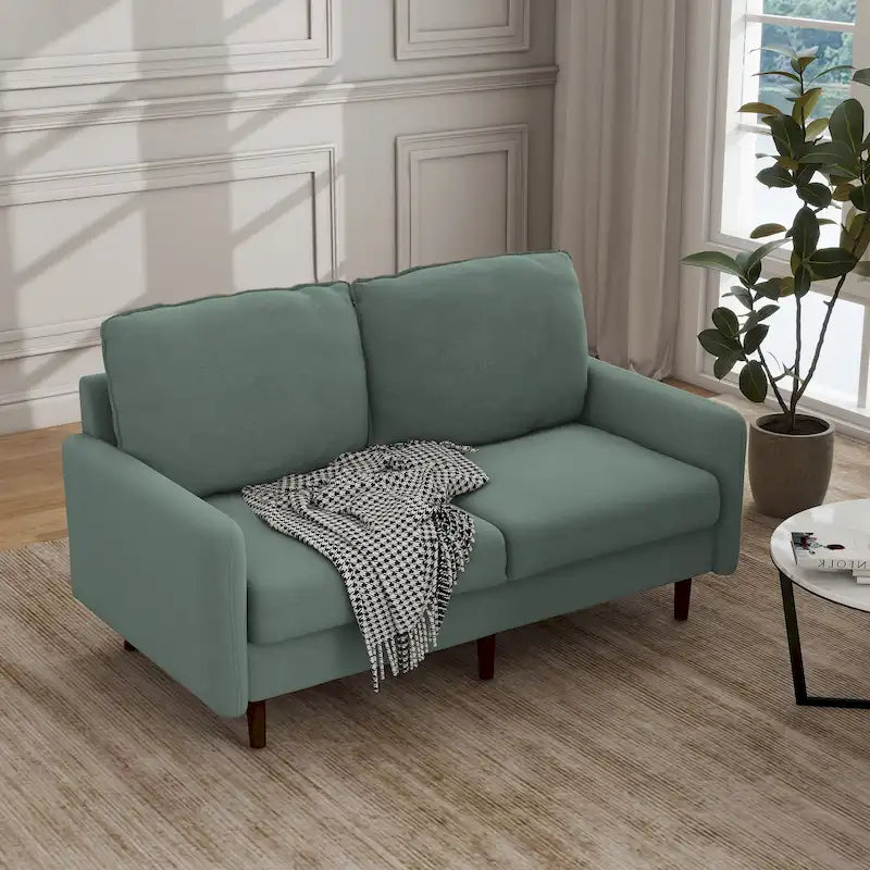 Divano moderno con gambe in legno e velluto